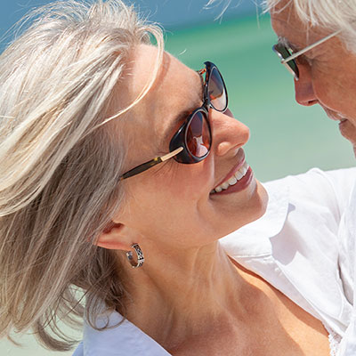 Happy Senior Couple Dancing Holding Hands on A Tropical Beach